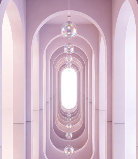 An endless corridor of pale pink arches